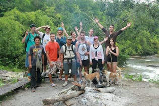 Group photo of friends in front of a forest area